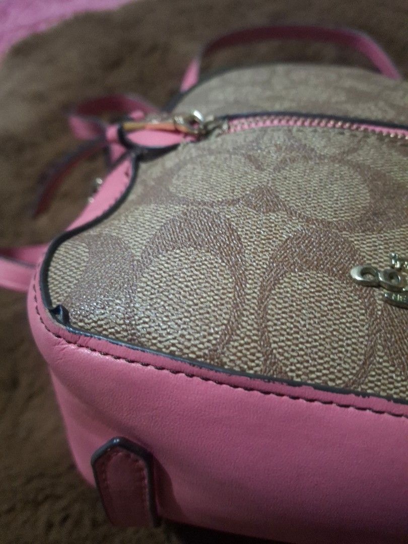 Mini Backpack (Category: Luxury Bags & Wallets) located in Lipa City. Submitted by kathethings (Listing ID 1437044537, Image 3). Description: - Coach mini backpack - Signature brown print with pink accents - Top handle and adjustable straps - Pink interior - Front zipper pocket - Gold-tone zipper - Made in Vietnam.