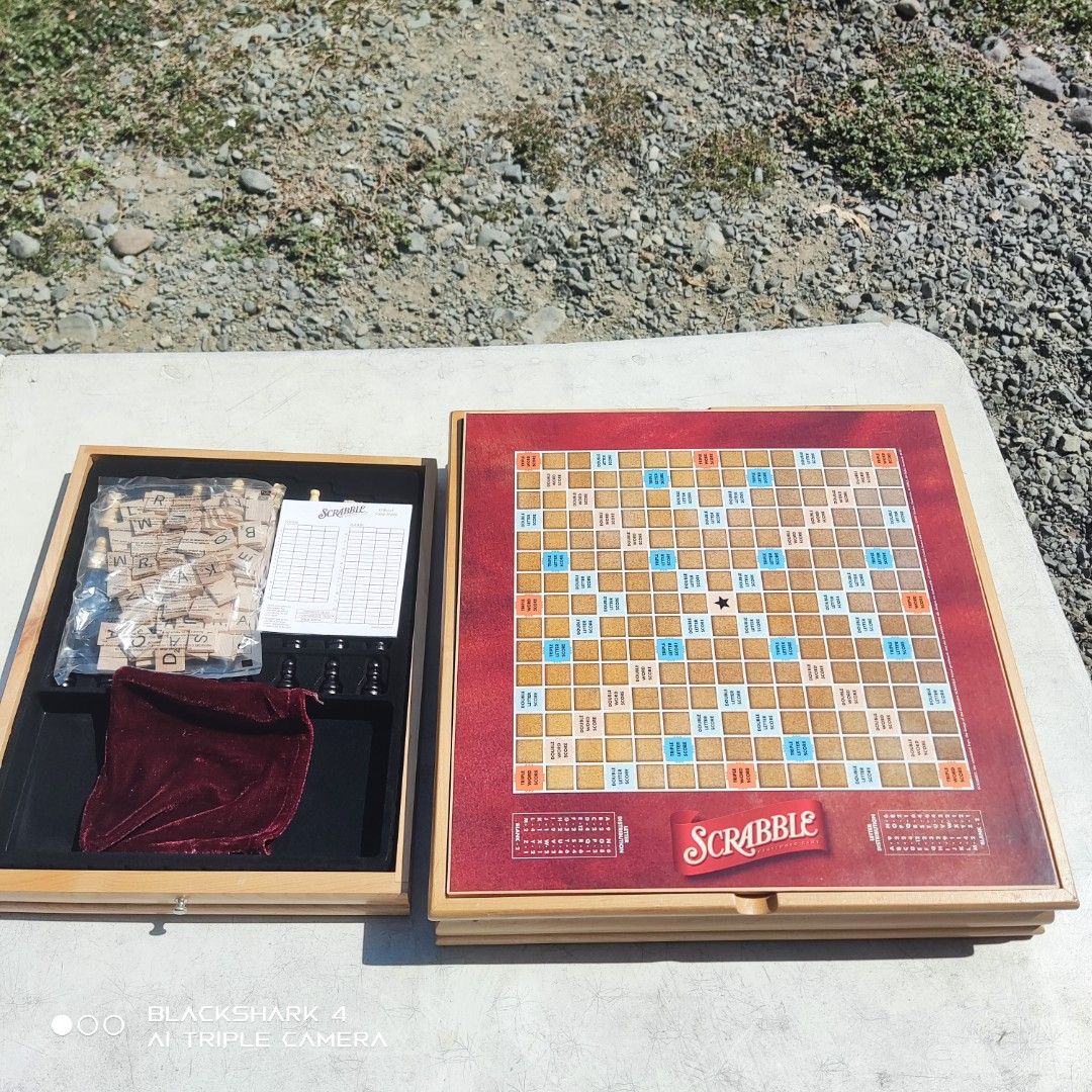 Monopoly and Scrabble Board Game Set (Category: Board Games & Puzzles) located in Bugallon. Submitted by ariel013 (Listing ID 1437054569, Image 3). Description: - Includes Monopoly, Scrabble, Chess, Checkers, Dominoes, and Poker Dice - Solid wood cabinet - Contains game boards, pieces, dice, and accessories - Great for family game nights and gatherings.