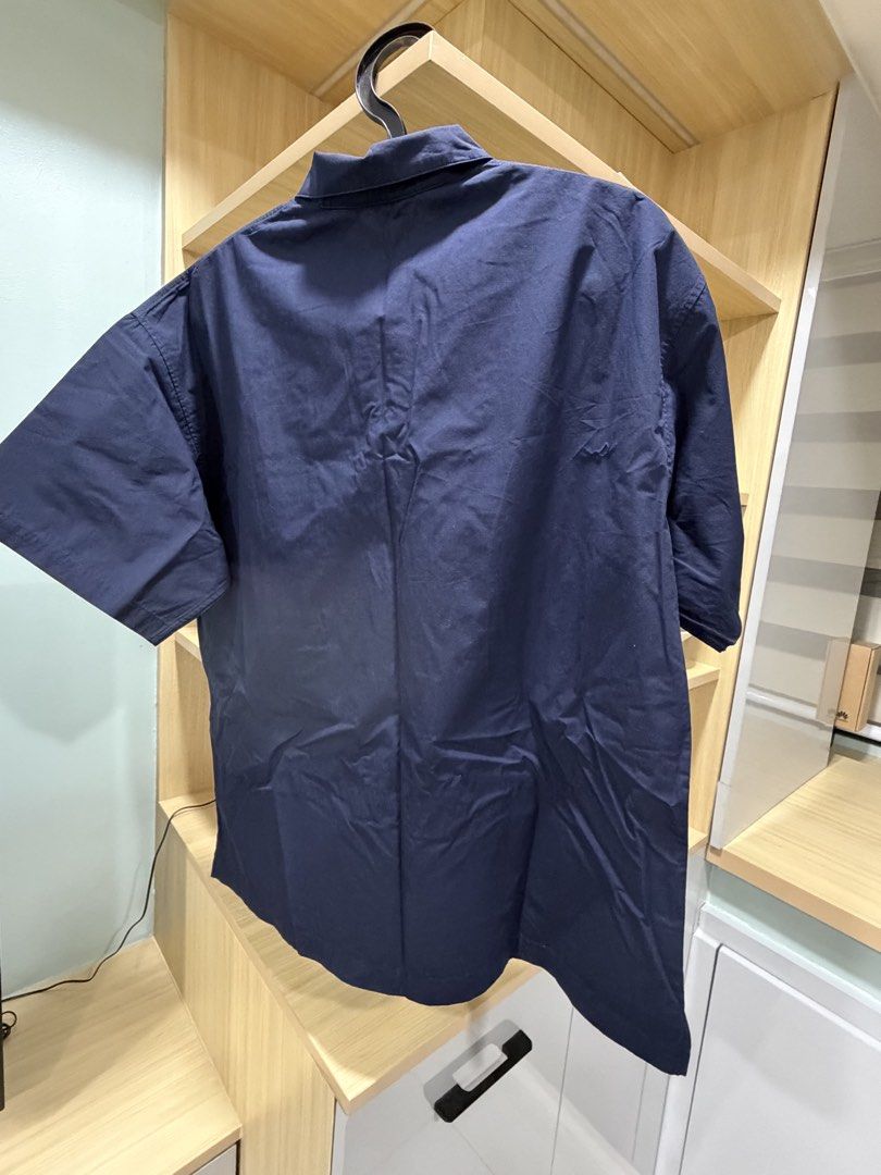 Navy Blue Short Sleeve Shirt - Size M (Category: Tshirts & Polo Shirts ) located in Mandaluyong City. Submitted by jpc0708 (Listing ID 1437132807, Image 3). Description: - Navy blue short sleeve shirt - Size: M - Features: - Single chest pocket - Button-up collar - Measurements: - Length: 27 inches - Width: 24 inches.