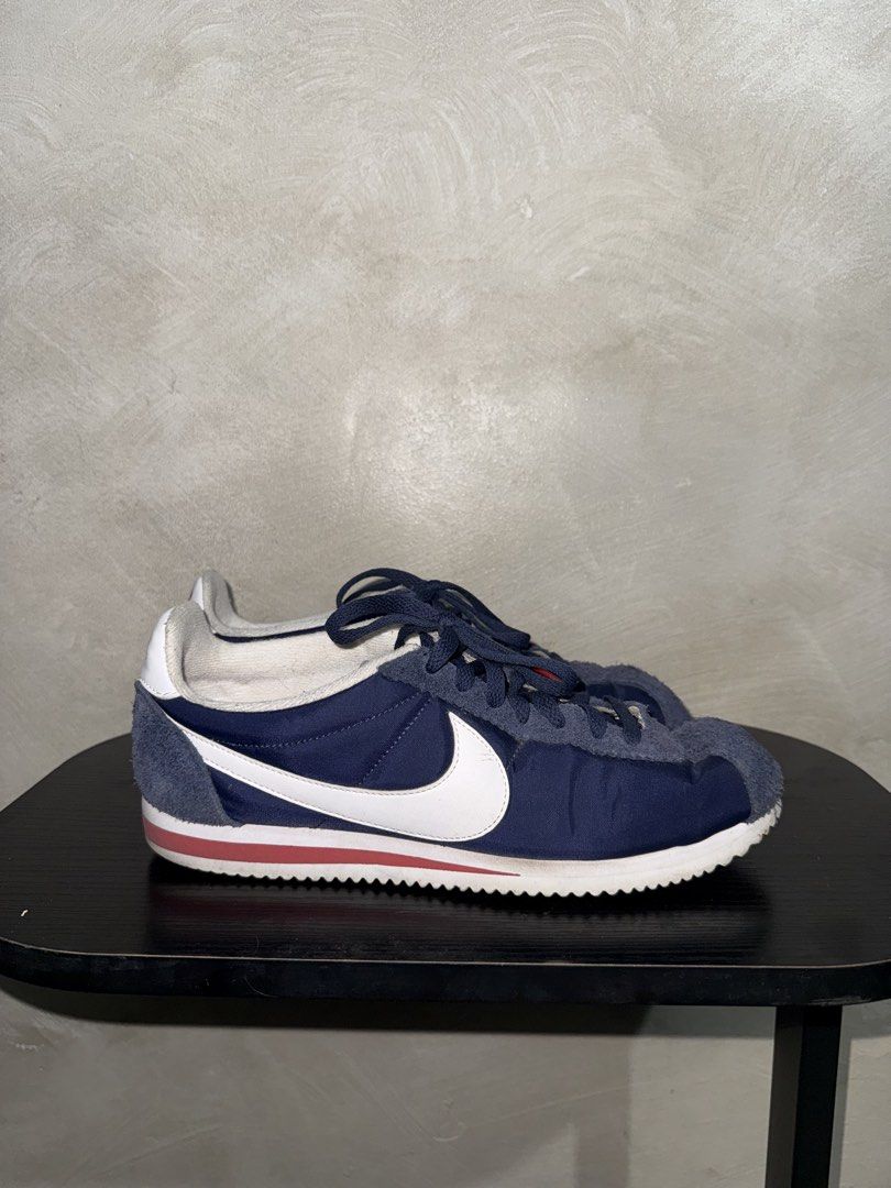 Nike Cortez Navy Blue Sneakers (Category: Sneakers) located in Mandaluyong City. Submitted by markqzn2 (Listing ID 1437114565, Image 2). Description: - Nike Cortez sneakers - Navy blue with white swoosh and red accents - Size: US 9.5, UK 8.5, EUR 43, 27.5 cm - Made in Indonesia - Signs of wear on soles and uppers - Manufacturing date: 08/03/16.