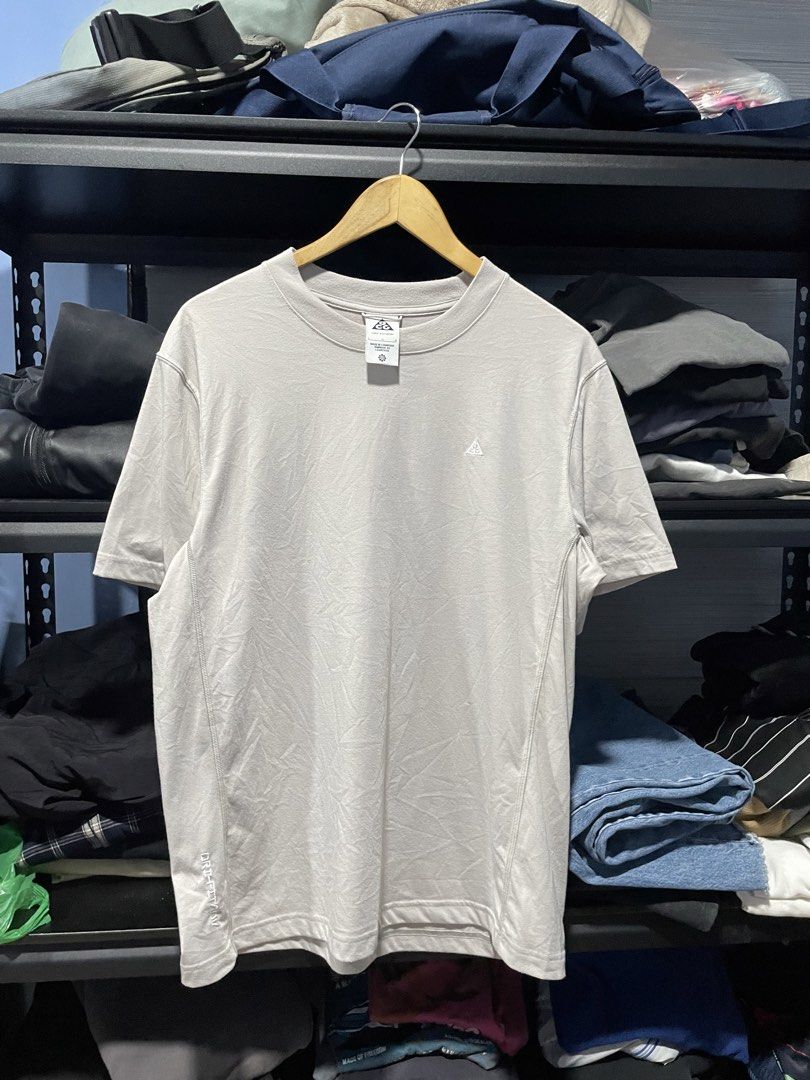 Nike Dri-Fit T-Shirt (Category: Activewear) located in Davao. Submitted by erwin_james (Listing ID 1437146761, Image 1). Description: - Nike collab with ACG Dri-Fit t-shirt - Light grey color - Size: Large - Features: Small Nike logo on chest, Dri-Fit technology - Made in Cambodia - Condition: Small hole or scratch on the side - Includes Goat Rocks tag - Dimension:21x27.