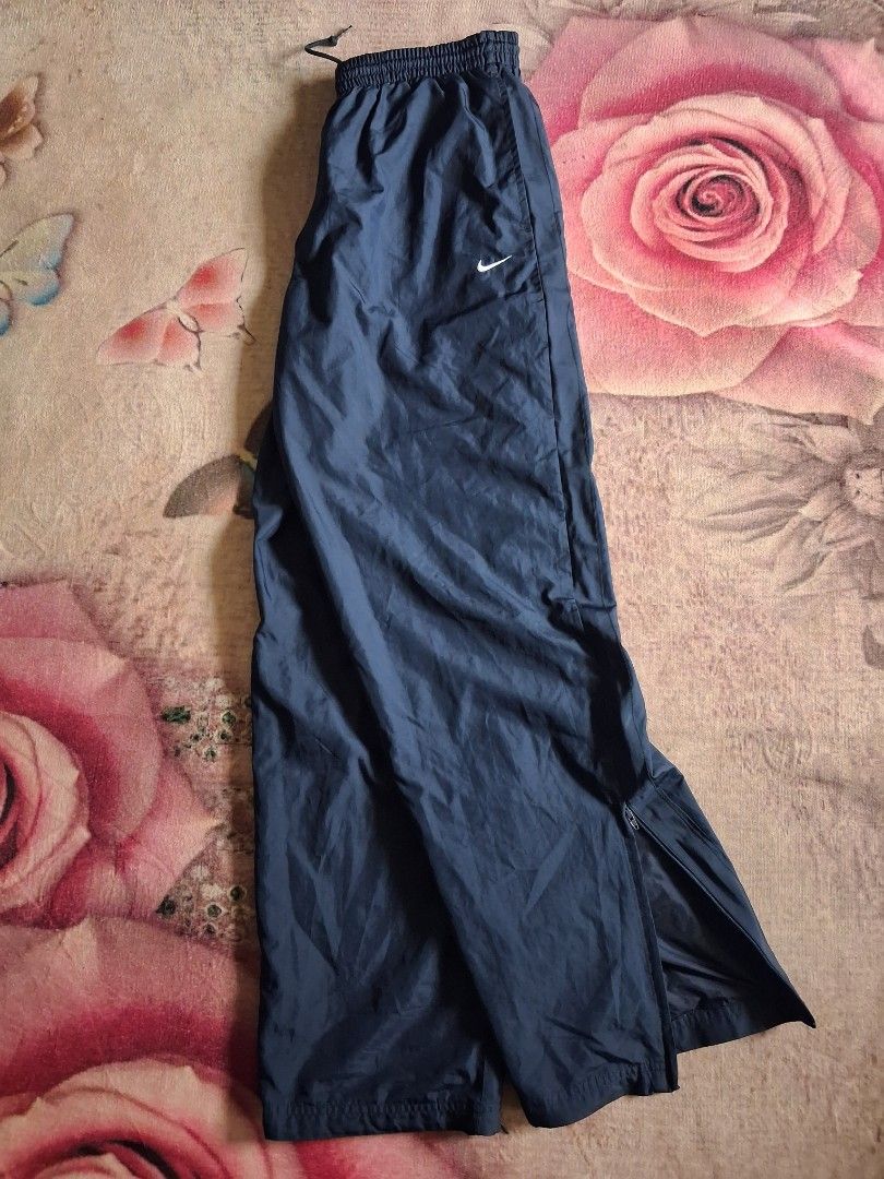 Nike trackpants with embroidered white swoosh (Category: Activewear) located in Giporlos. Submitted by berniee21 (Listing ID 1437036639, Image 1). Description: 480 shipped nalang to asnew condition pinhole sa likod just below the knee maliit lang.