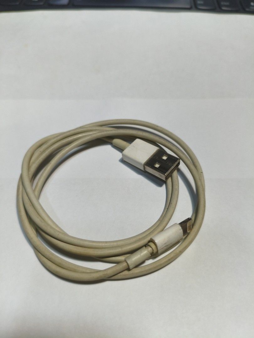 Original Apple Lightning to USB Cable (Category: Chargers & Cables) located in Pasig City. Submitted by coolphoenix-29ac (Listing ID 1437157386, Image 1). Description: - Authentic Apple Lightning to USB cable - Color: White - Standard charging cable for Apple devices - USB-A to Lightning connectors - Coiled and ready for use.