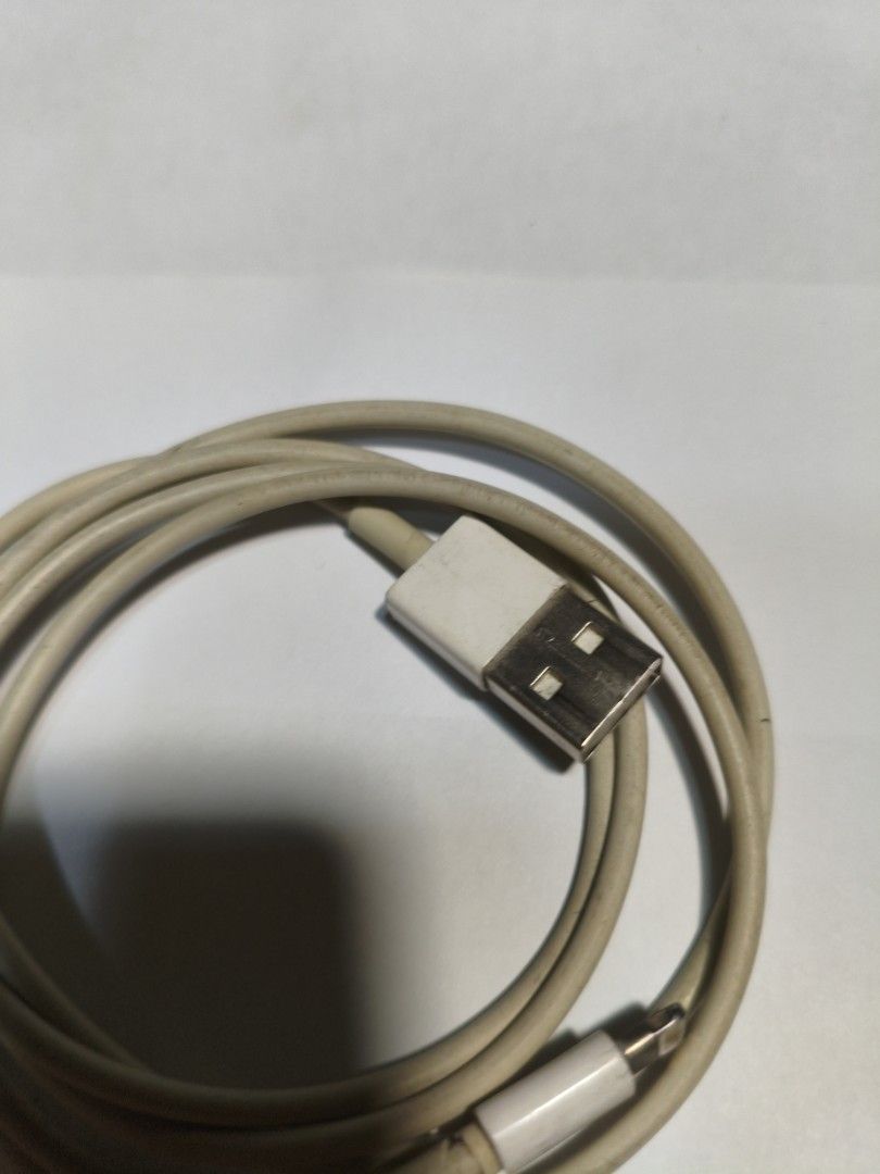 Original Apple Lightning to USB Cable (Category: Chargers & Cables) located in Pasig City. Submitted by coolphoenix-29ac (Listing ID 1437157386, Image 3). Description: - Authentic Apple Lightning to USB cable - Color: White - Standard charging cable for Apple devices - USB-A to Lightning connectors - Coiled and ready for use.