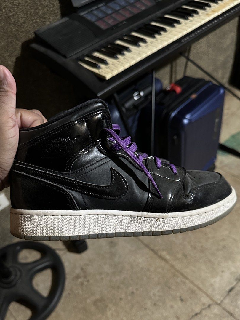Original Jordan 1 Space Jam (Category: Sneakers) located in Marikina City. Submitted by patriciaoriendo2 (Listing ID 1437206319, Image 1). Description: Black Nike Air Jordan 1 Mid sneakers with purple laces. Features a black leather upper with a white midsole and a black swoosh. Perfect for casual wear or adding a touch of style to any outfit..