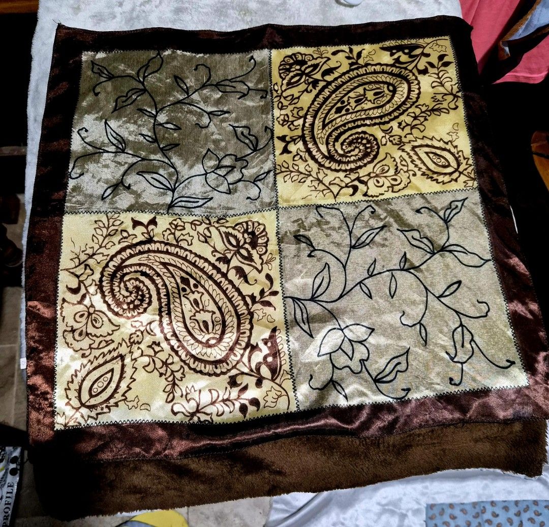 Paisley Pattern Table Runner 20 x 20 inches (Category: Table Linen & Textiles) located in Mandaue City. Submitted by chuchi152615 (Listing ID 1437020971, Image 2). Description: - Square table runner - Features paisley and floral designs - Color scheme: Brown and gold with a dark brown border - Made of silky material - Dimensions: Approximately 20 inches x 20 inches.
