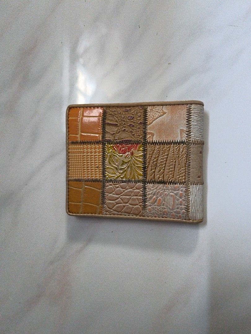 Patchwork Wallet (Category: Wallets & Card Holders) located in Singapore. Submitted by fern.8y428b (Listing ID 1437060327, Image 3). Description: - Unique patchwork leather design - Multiple compartments - Includes card slots - Features a zippered pocket - Light beige interior - Brand logo visible - Stylish and functional.