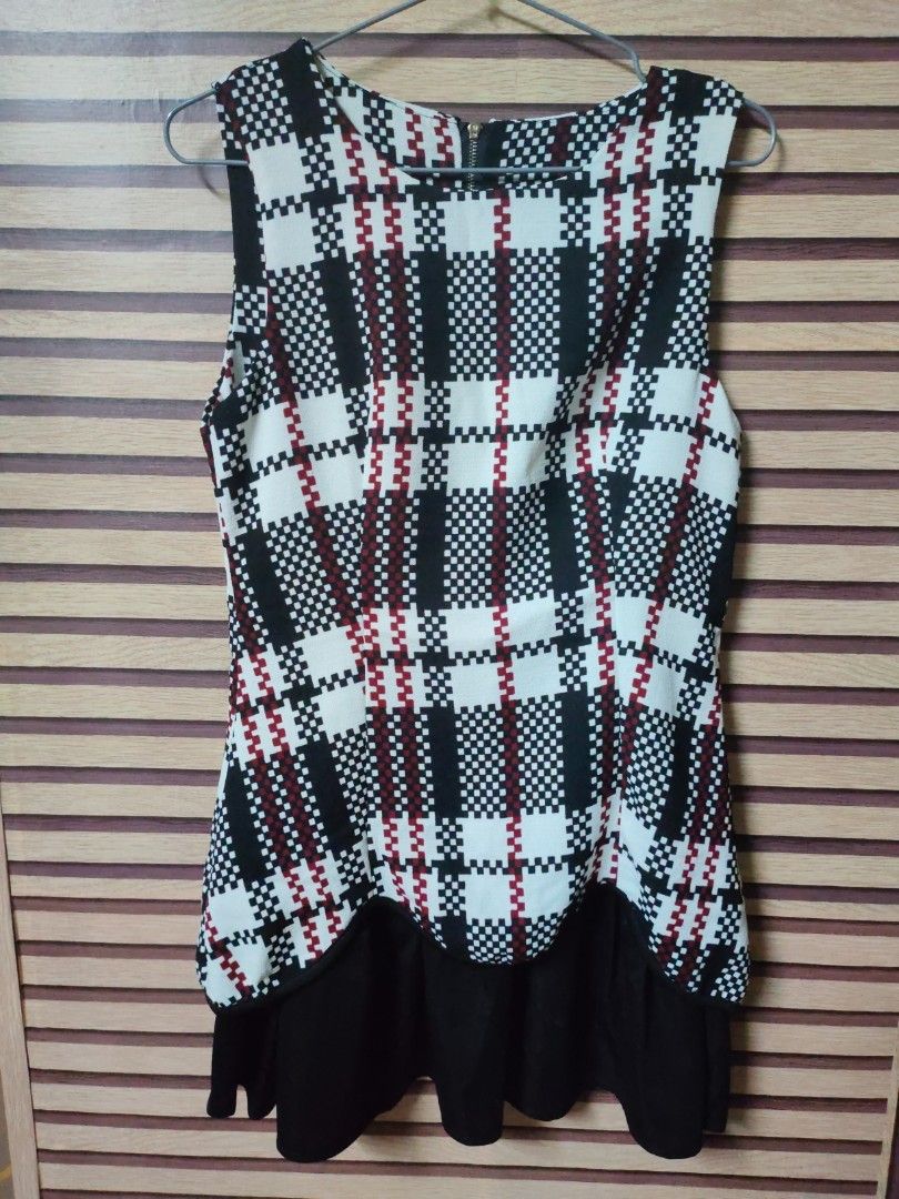 Plaid Sleeveless Dress (Category: Dresses) located in Makati City. Submitted by mybentables (Listing ID 1437151233, Image 1). Description: - Sleeveless dress - Black, white, and red plaid pattern - Fitted bodice - Flared skirt - Black ruffle hem detail - Back zipper closure - Suitable for various occasions -Tagged as free size because when bought, there was no size tag.