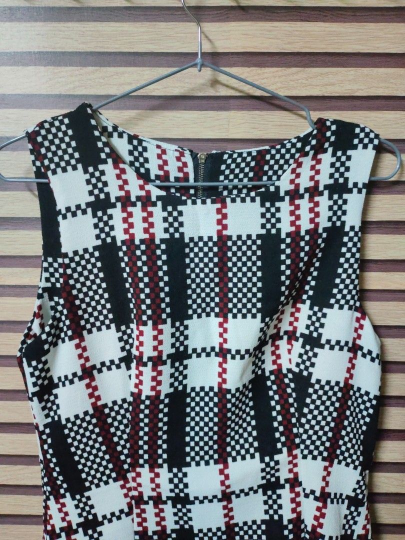 Plaid Sleeveless Dress (Category: Dresses) located in Makati City. Submitted by mybentables (Listing ID 1437151233, Image 2). Description: - Sleeveless dress - Black, white, and red plaid pattern - Fitted bodice - Flared skirt - Black ruffle hem detail - Back zipper closure - Suitable for various occasions -Tagged as free size because when bought, there was no size tag.