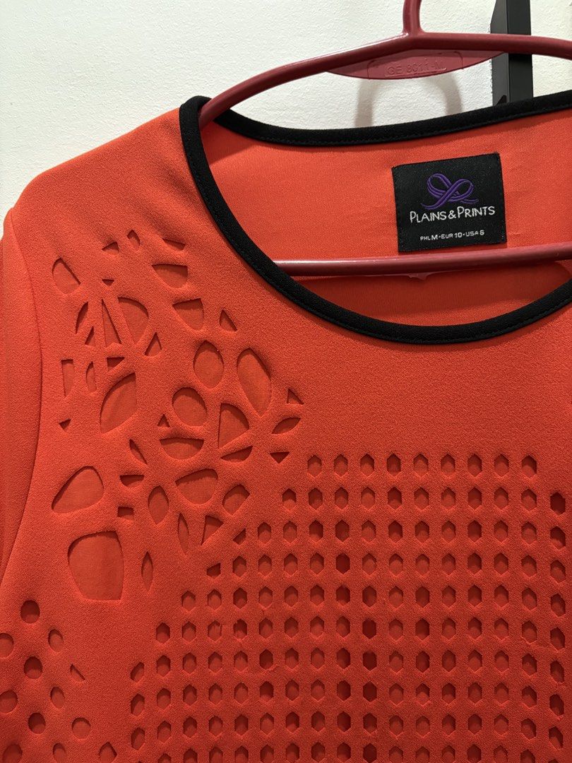 Plains & Prints Laser Cut Top (Category: Blouses) located in Las Pinas. Submitted by jclb13 (Listing ID 1437124324, Image 3). Description: - Plains & Prints top - Unique laser-cut design on the front - Round neckline - Short sleeves with black trim - Solid orange back - Size: PHL M, EUR 10, USA 6.