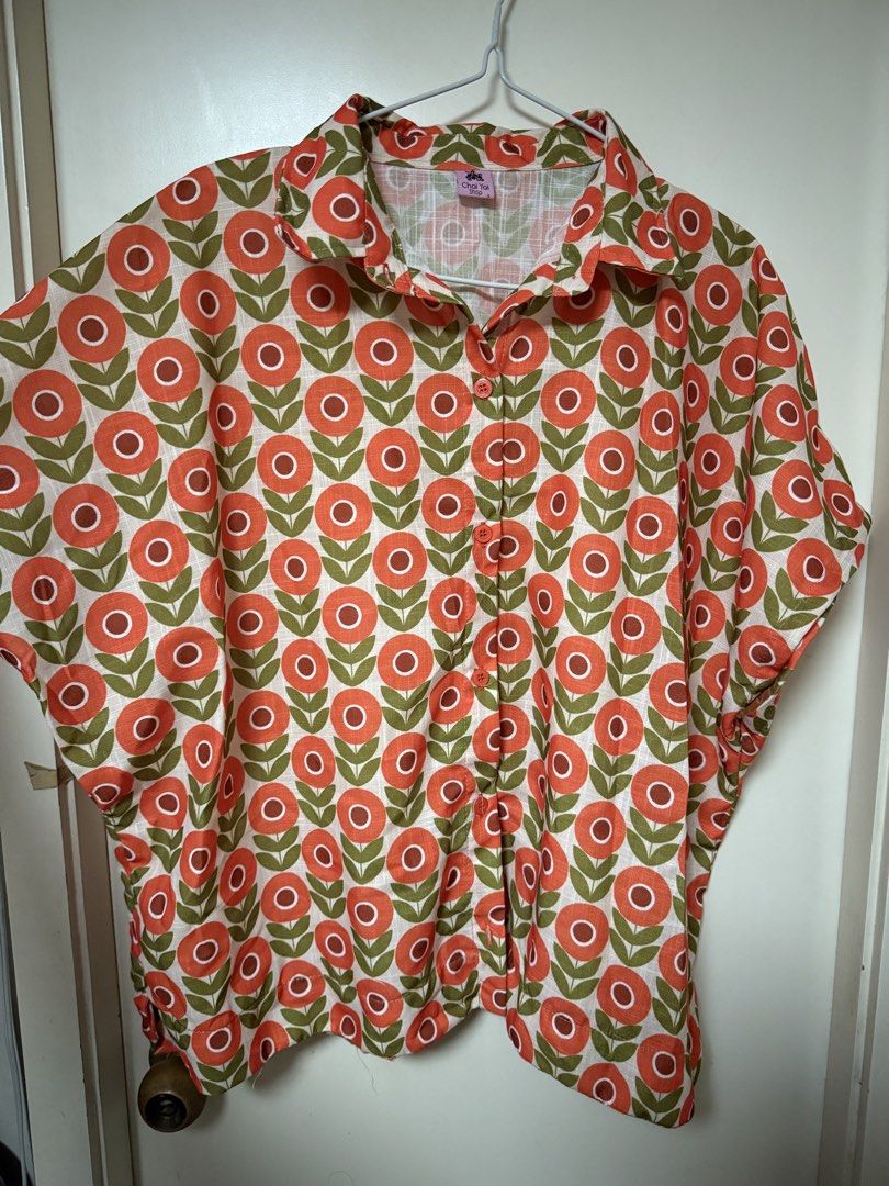Plus size Floral Button-Down Top - XL to 2XL (Category: Blouses) located in Taytay. Submitted by thriftstoreadventures (Listing ID 1437078404, Image 2). Description: Bought in Thailand for ₱550. Never used. I find it short for my height. 23 inches length. Perfect for XL to 2XL frames. Cute with shorts - Floral print in orange and green - Button-down front - Short sleeves - Lightweight fabric - Collared neckline - Relaxed fit - Ideal for warm weat