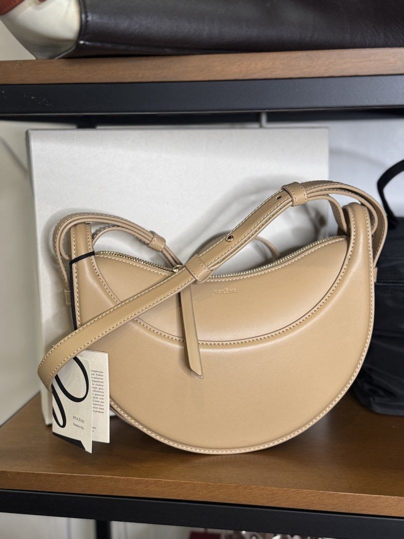 Polène Numéro Dix Bag (Category: Luxury Bags & Wallets) located in Butuan. Submitted by sostephd (Listing ID 1437097467, Image 1). Description: - Polène Numéro Dix bag - Color: Tan - Shape: Crescent - Closure: Top zipper - Strap: Detachable shoulder strap - Design: Minimalist - Features: Subtle brand logo - Condition: New with original tag/ extra straps/ box (complete inclusions).