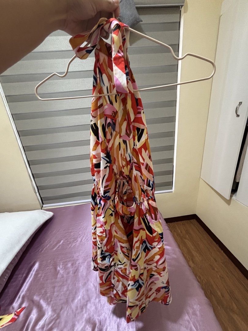 Printed Halter Neck Backless Dress (Category: Dresses) located in Las Pinas. Submitted by drecessionista (Listing ID 1437059410, Image 2). Description: - Abstract print halter neck dress - Features an elasticated waist - Flowing skirt design - Includes a matching fabric belt - Color scheme: red, yellow, and orange - Ideal for casual occasions.