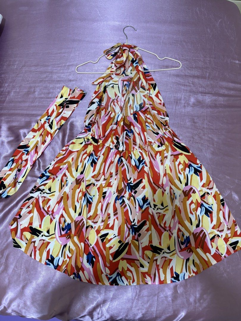 Printed Halter Neck Backless Dress (Category: Dresses) located in Las Pinas. Submitted by drecessionista (Listing ID 1437059410, Image 3). Description: - Abstract print halter neck dress - Features an elasticated waist - Flowing skirt design - Includes a matching fabric belt - Color scheme: red, yellow, and orange - Ideal for casual occasions.