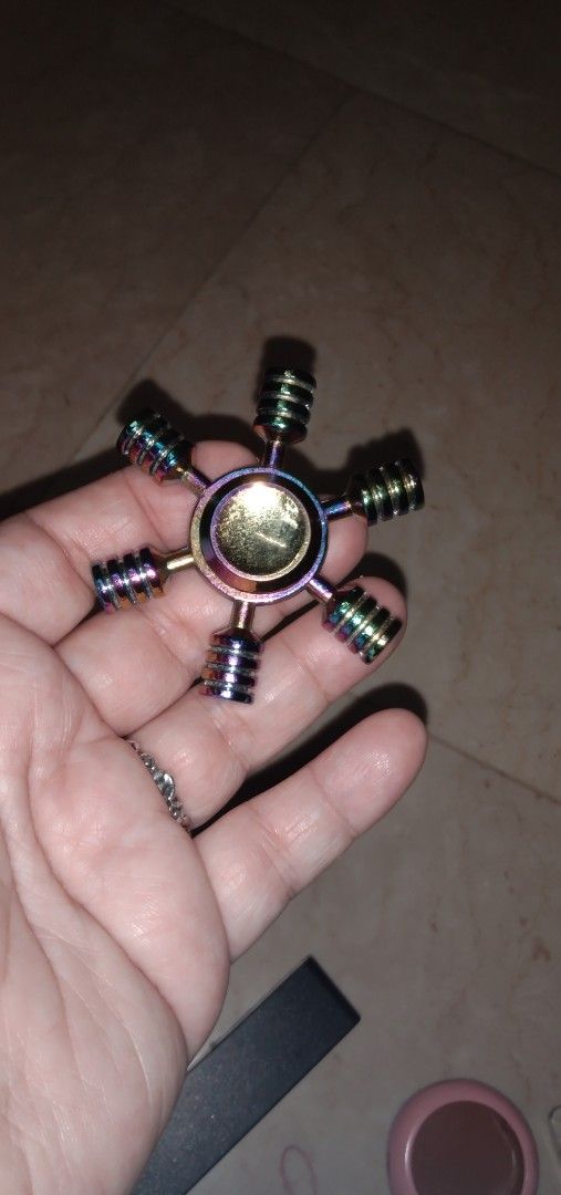 Rainbow Metal Fidget Spinner (Category: Action & Battle Toys) located in Quezon City. Submitted by eidorableshop (Listing ID 1437192111, Image 2). Description: - Rainbow colored fidget spinner - Six-arm metal design - Smooth spinning action - Great for stress relief - Durable construction.