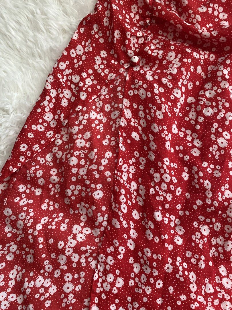 Red Floral Midi Skirt (Category: Skirts) located in Makati City. Submitted by valerie.as (Listing ID 1437104777, Image 3). Description: - waist: 28-29 inches - length: 29 inches - Red midi skirt - White floral pattern - Side slit detail - Button accents - Lightweight fabric.
