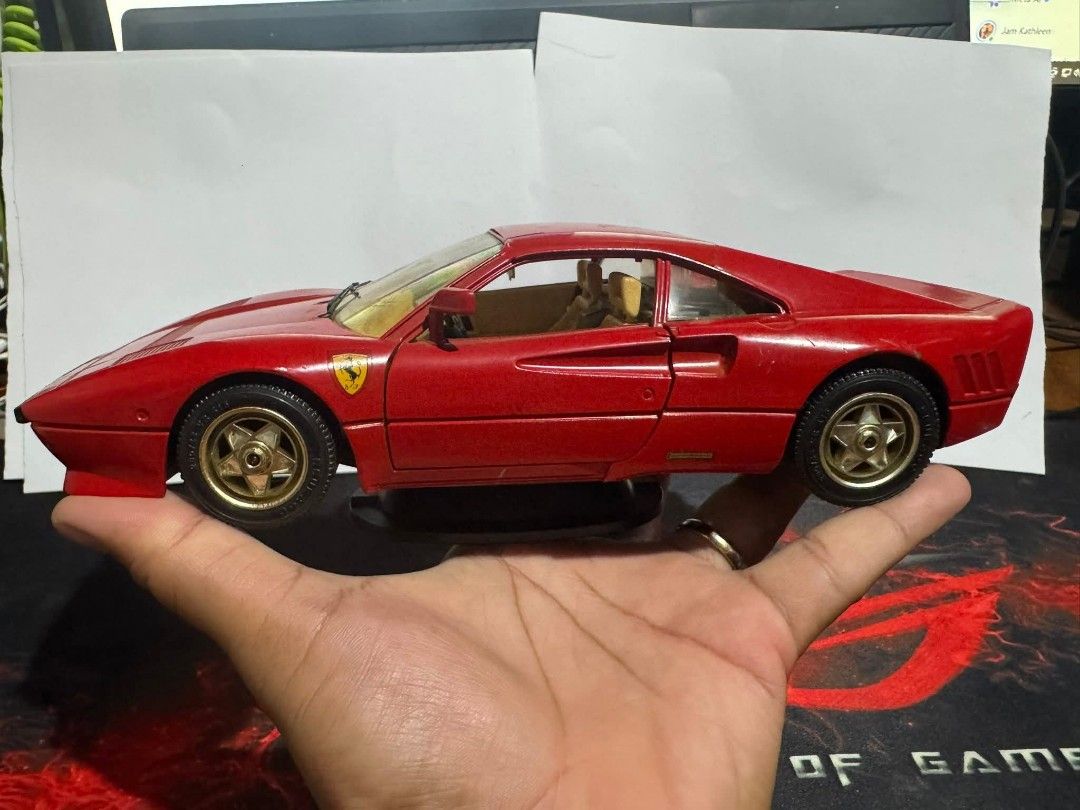 Red Shelby Cobra Toy Car (Category: Vehicle & Diecast Models) located in Davao. Submitted by rkkentmusi08036 (Listing ID 1437192872, Image 2). Description: Red Shelby Cobra toy car with gold-colored wheels. It has a convertible top and black interior. The car is held in a hand, showing its size and details..