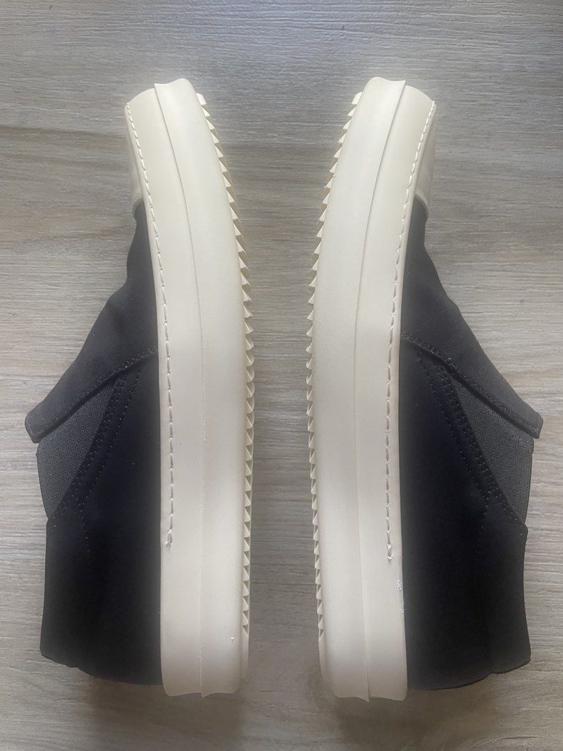 Rick Owens Slip-On Sneakers (Category: Sneakers & Footwear) located in Iloilo. Submitted by darvoza (Listing ID 1437114988, Image 3). Description: Black slip-on sneakers with a white toe cap and sole. The shoes have a thick sole and a minimalist design. The shoes have a low-top design and are likely comfortable for everyday wear. With minimal garter alteration and leather replaced insole for more comfort Size EU 40 and made in Italy With no inclu