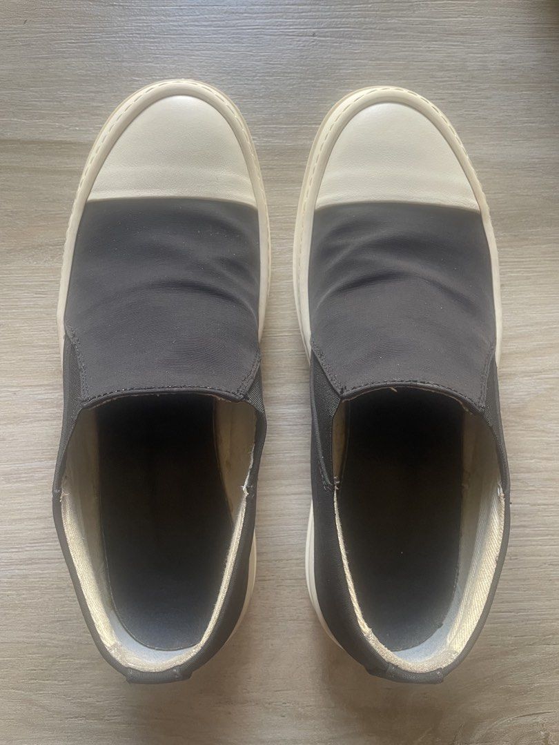 Rick Owens Slip-On Sneakers (Category: Sneakers & Footwear) located in Iloilo. Submitted by darvoza (Listing ID 1437114988, Image 2). Description: Black slip-on sneakers with a white toe cap and sole. The shoes have a thick sole and a minimalist design. The shoes have a low-top design and are likely comfortable for everyday wear. With minimal garter alteration and leather replaced insole for more comfort Size EU 40 and made in Italy With no inclu