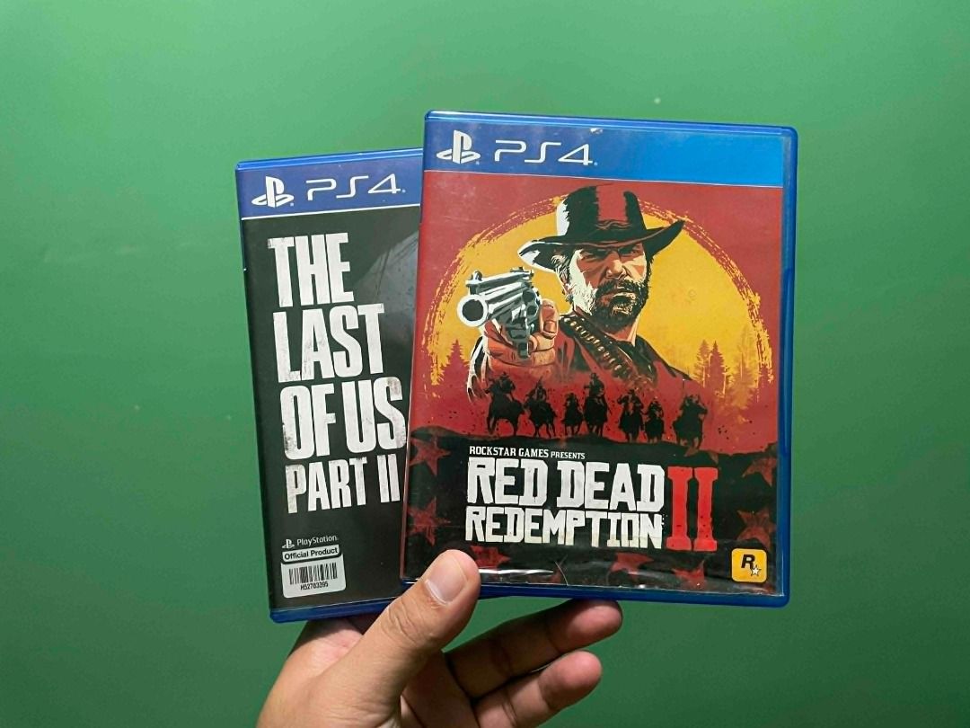 Sony PlayStation 4 with Games and Controller (Category: PlayStation) located in Manila. Submitted by bastianemutan (Listing ID 1437062910, Image 2). Description: Includes a black Sony PlayStation 4 console, a black controller with a charging dock, and two games: Red Dead Redemption 2 and The Last of Us Part II. The console has a Cyberpunk 2077 sticker on it..