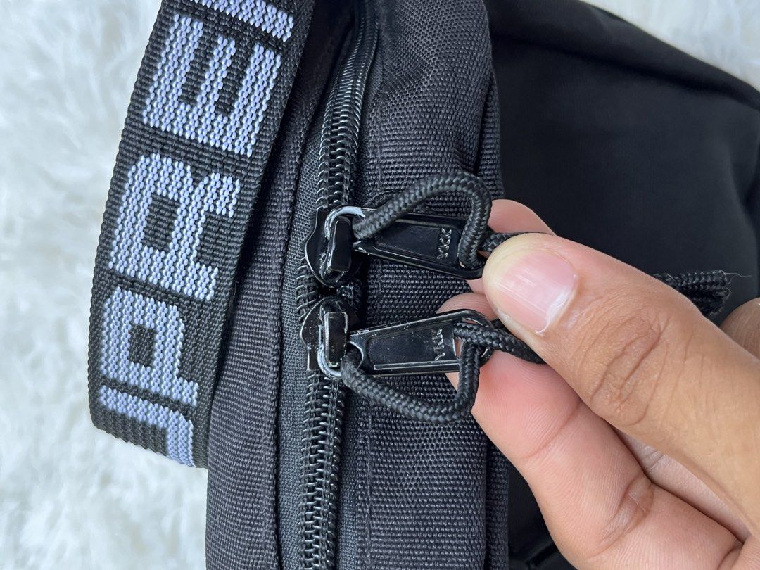 Supreme Shoulder Bag Black SS18 (Category: Luxury Bags & Wallets) located in Davao. Submitted by streetsight (Listing ID 1437115644, Image 3). Description: - Black Supreme shoulder bag - White logo strap - Front zip pocket - Main compartment - Supreme logo on front - Zipper closure - Supreme logo on strap - Durable, possibly nylon material.