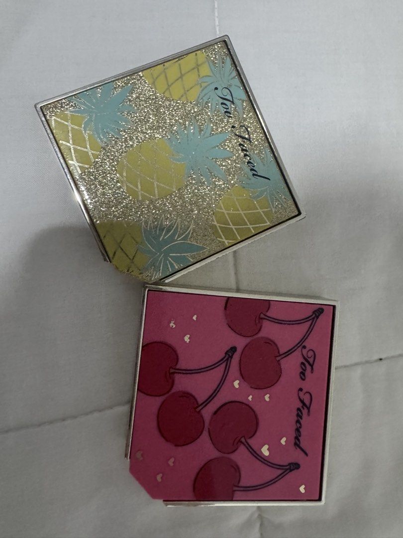Too Faced Pineapple & Cherry Blush Duo (Category: Makeup) located in Manila. Submitted by decluterthings888 (Listing ID 1437202884, Image 2). Description: - Two Too Faced blush duos for sale! - Pineapple Paradise & Bronzer: - Yellow case with glittery pineapple design. - Fruit Cocktail Blush Duo in Cherry Bomb: - Pink case with cherry designs. - Both duos include a mirror and are in compact cases..