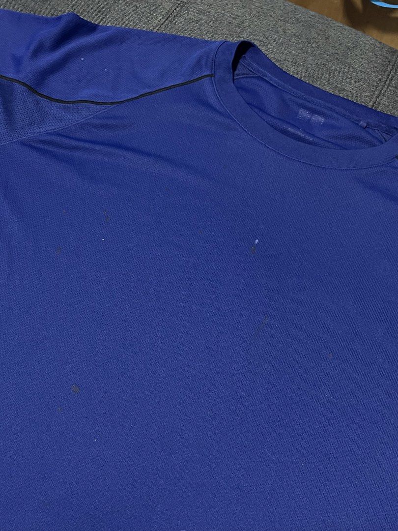 Uniqlo Blue Athletic Drifit Shirt (Category: Tshirts & Polo Shirts ) located in Marikina City. Submitted by d.clutters (Listing ID 1437116433, Image 2). Description: - Blue athletic t-shirt - Black accents - Crew neck - Short sleeves - Some spots on front - Breathable, possibly moisture-wicking material - Suitable for sports or casual wear.