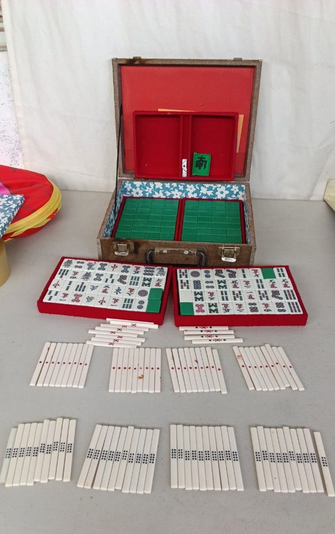 Japan Vintage Mini Mahjong Set with Case Mini Size (Category: Board Games & Puzzles) located in Bulacan. Submitted by amarijapansurplus (Listing ID 1437100905, Image 1). Description: - Complete vintage Minis Size Mahjong set - Includes tiles, racks, dice, and case - Case features a red interior and a handle - Tiles are white with black and green markings - Comes with a set of instructions.
