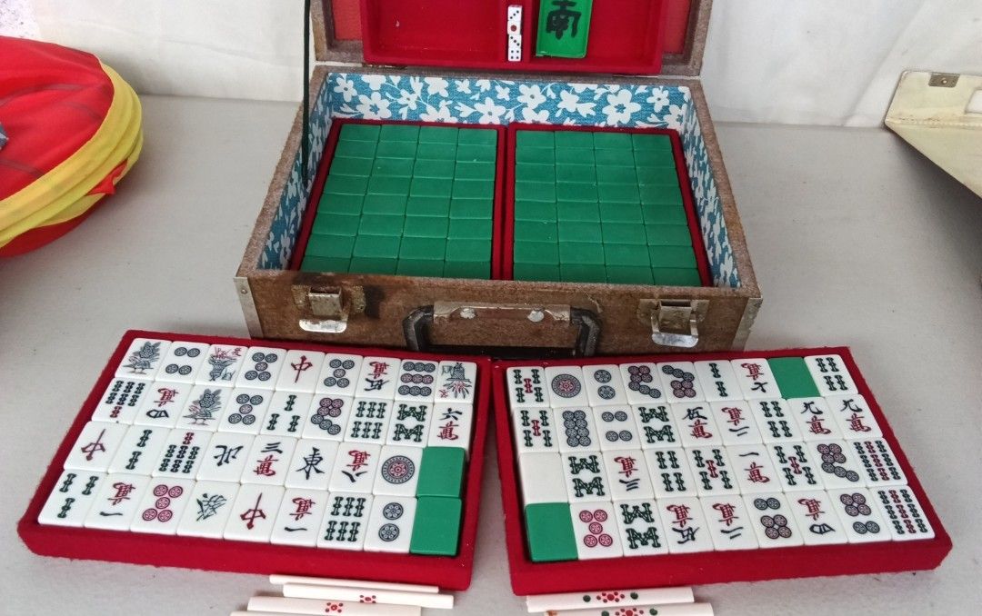 Japan Vintage Mini Mahjong Set with Case Mini Size (Category: Board Games & Puzzles) located in Bulacan. Submitted by amarijapansurplus (Listing ID 1437100905, Image 3). Description: - Complete vintage Minis Size Mahjong set - Includes tiles, racks, dice, and case - Case features a red interior and a handle - Tiles are white with black and green markings - Comes with a set of instructions.