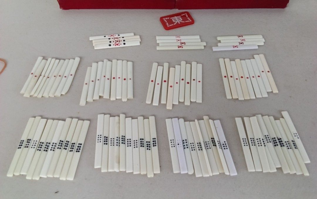 Vintage MINI Mahjong Set with Case mini size (Category: Board Games & Puzzles) located in Bulacan. Submitted by amarijapansurplus (Listing ID 1437107543, Image 2). Description: - Vintage mini size mahjong set (144 tiles, 88sticks) - Includes tiles, racks, and case - Tiles feature green and white designs - Red interior case with handle - Includes a red "東" tile - no dice.