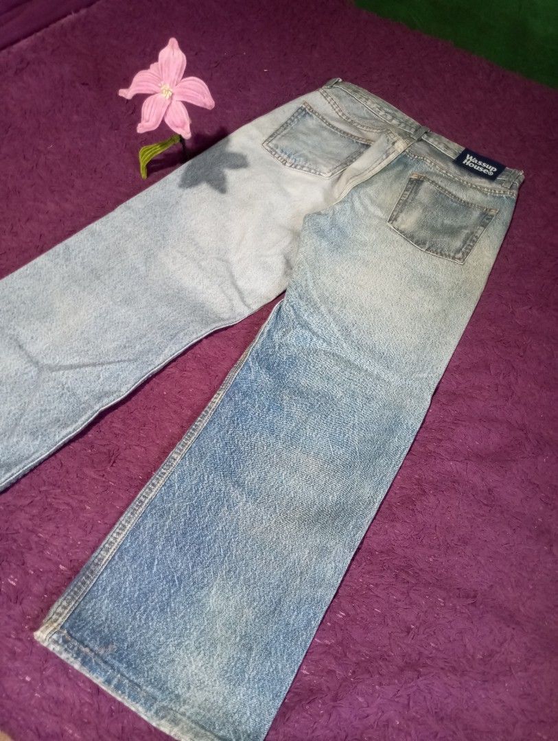 Wassup House Jeans (Category: Jeans) located in Manila. Submitted by johnpaulnoga29 (Listing ID 1437066239, Image 2). Description: Light wash denim jeans from Wassup House. Features a classic five-pocket design with a straight leg fit. The jeans have a button and zipper closure. The back pocket has a Wassup House label. The jeans have some fading and distressing..