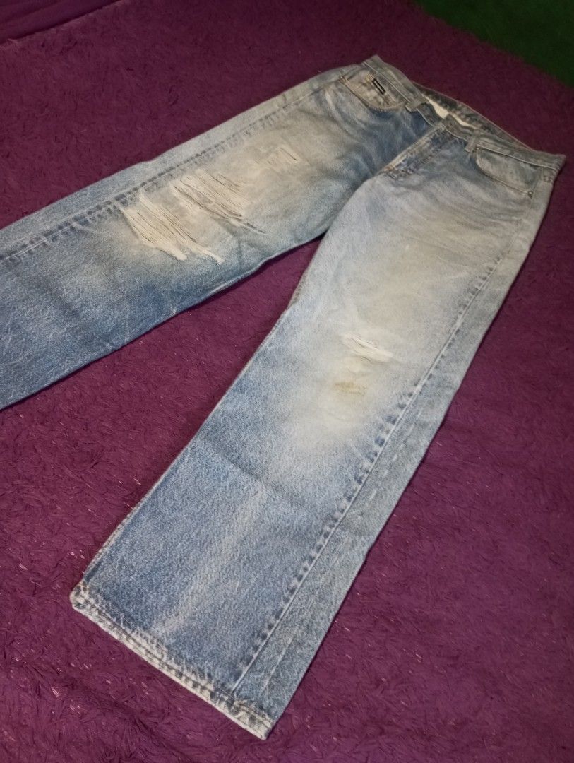 Wassup House Jeans (Category: Jeans) located in Manila. Submitted by johnpaulnoga29 (Listing ID 1437066239, Image 1). Description: Light wash denim jeans from Wassup House. Features a classic five-pocket design with a straight leg fit. The jeans have a button and zipper closure. The back pocket has a Wassup House label. The jeans have some fading and distressing..