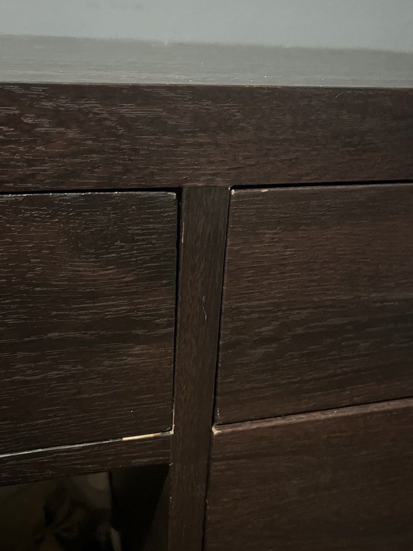 Wooden Desk with Drawers (Category: Tables & Sets) located in Cavite. Submitted by purploise (Listing ID 1437057544, Image 3). Description: - Dark brown wooden desk - Multiple drawers and a shelf - Lock on top drawer doesn’t work - Shows wear and tear - Two smaller drawers on the right - One larger drawer on the left - Suitable for home or office use.