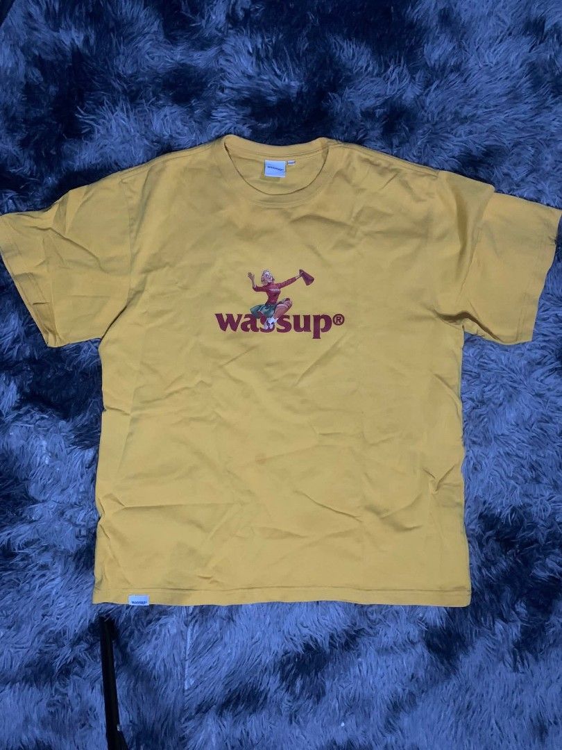 Yellow Wassup T-shirt (Category: Tshirts & Polo Shirts ) located in Tarlac. Submitted by rhandell_collectives (Listing ID 1437114782, Image 1). Description: - Yellow t-shirt - "Wassup" graphic on the front - Short sleeves - Crew neck - Made of a cotton blend - Features a cartoon character.