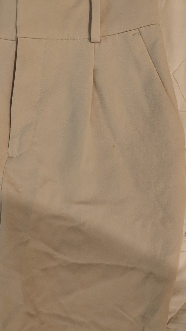 Zara high waisted Cream Trousers (Category: Other Bottoms) located in Makati City. Submitted by shopsaleph (Listing ID 1437093910, Image 3). Description: - cream high-waisted trousers - Pleated front - Straight leg - Lightweight fabric - Two front and two back pockets - Button and zipper closure has a tiny tiny stain.not noticeable when worn .