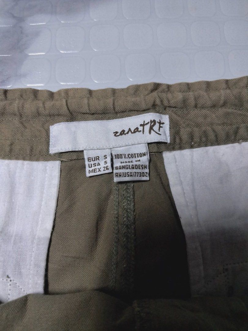 Zara TRF Small Olive Green Cropped Pants (Category: Other Bottoms) located in Baguio. Submitted by padisellsz (Listing ID 1437124097, Image 2). Description: - Zara TRF olive green pants - Very good condition - No issues - Size: Small - Features: - Drawstring waist - Ankle tie details - Two front pockets - One back pocket - Material: 100% cotton - Size details: EUR S, USA S, MEX 26 - Made in Bangladesh.