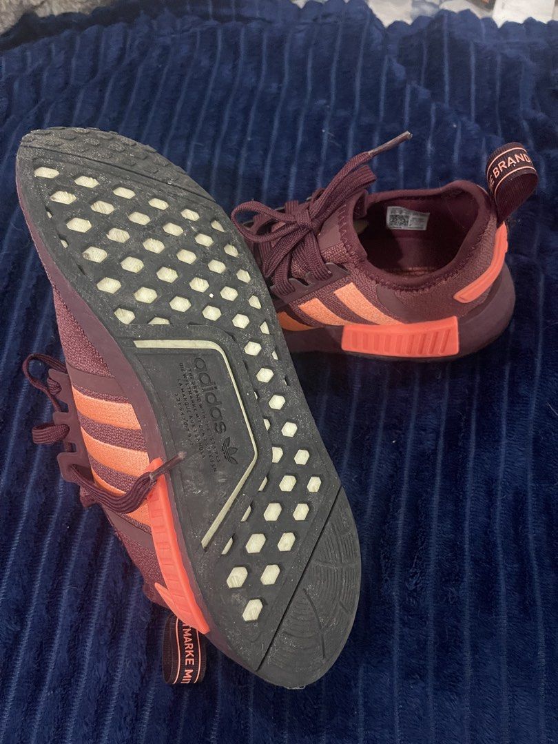 Adidas NMD Sneakers (Category: Sneakers) located in Paranaque City. Submitted by politzki (Listing ID 1437365038, Image 2). Description: - Adidas NMD sneakers - Maroon and orange colorway - Adidas logo on tongue - Adidas branding on heel tab - White cushioned sole - Fabric upper - Shows wear on soles -7.5 womens fits up to 8 -Almost new used once With box .