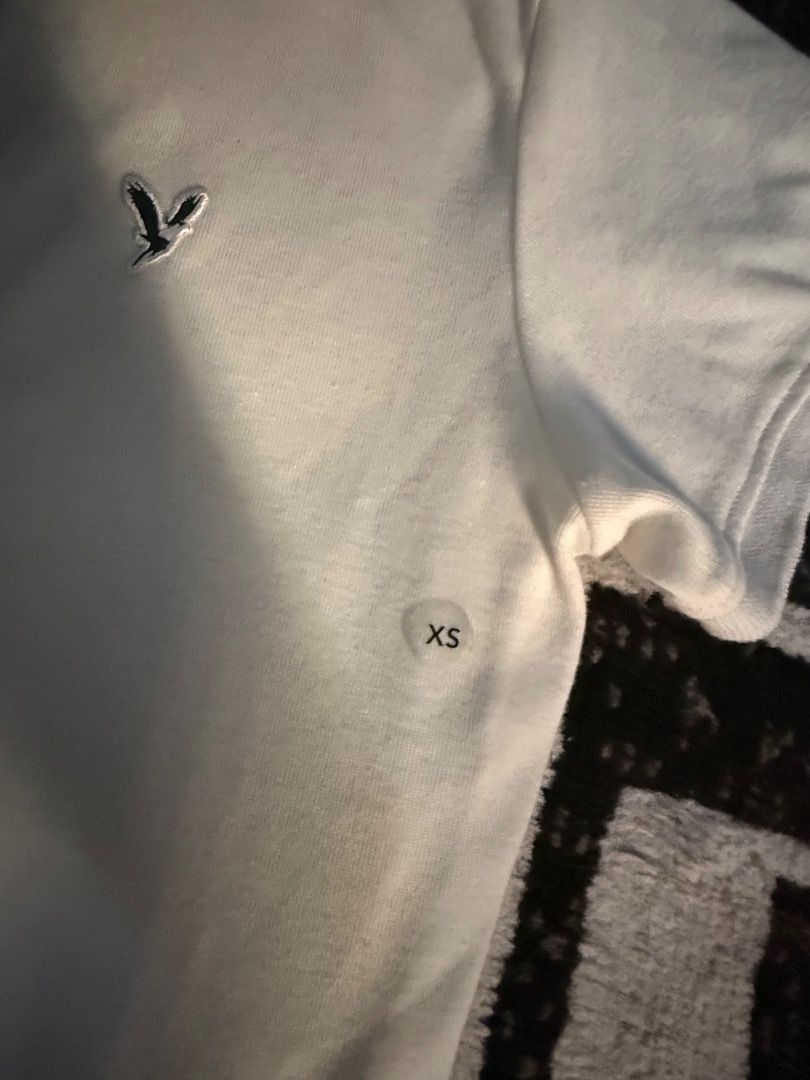 American Eagle White Polo Shirt XS (Category: Shirts) located in Caloocan City. Submitted by kaylashop1 (Listing ID 1437384893, Image 3). Description: - American Eagle white polo shirt - Size: XS - Classic collar - Short sleeves - American Eagle logo on chest - BRAND NEW WITH TAGS!.