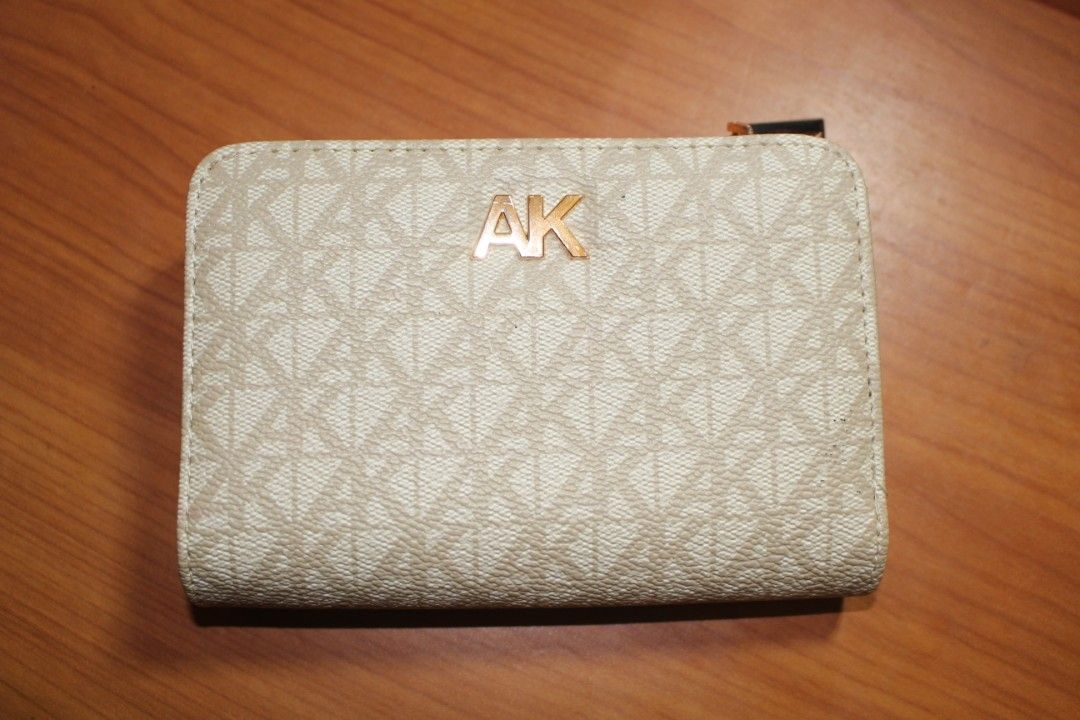 Anne Klein Wallet (Category: Luxury Bags & Wallets) located in Tarlac. Submitted by trishatrish3 (Listing ID 1437268886, Image 1). Description: Cream-colored Anne Klein monogram snap wallet featuring a gold-toned AK logo on the front.