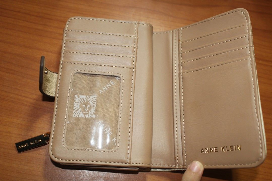 Anne Klein Wallet (Category: Luxury Bags & Wallets) located in Tarlac. Submitted by trishatrish3 (Listing ID 1437268886, Image 3). Description: Cream-colored Anne Klein monogram snap wallet featuring a gold-toned AK logo on the front.