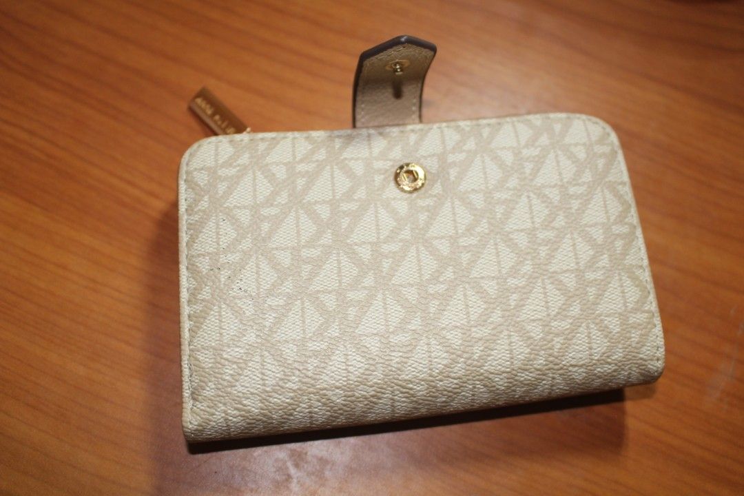 Anne Klein Wallet (Category: Luxury Bags & Wallets) located in Tarlac. Submitted by trishatrish3 (Listing ID 1437268886, Image 2). Description: Cream-colored Anne Klein monogram snap wallet featuring a gold-toned AK logo on the front.