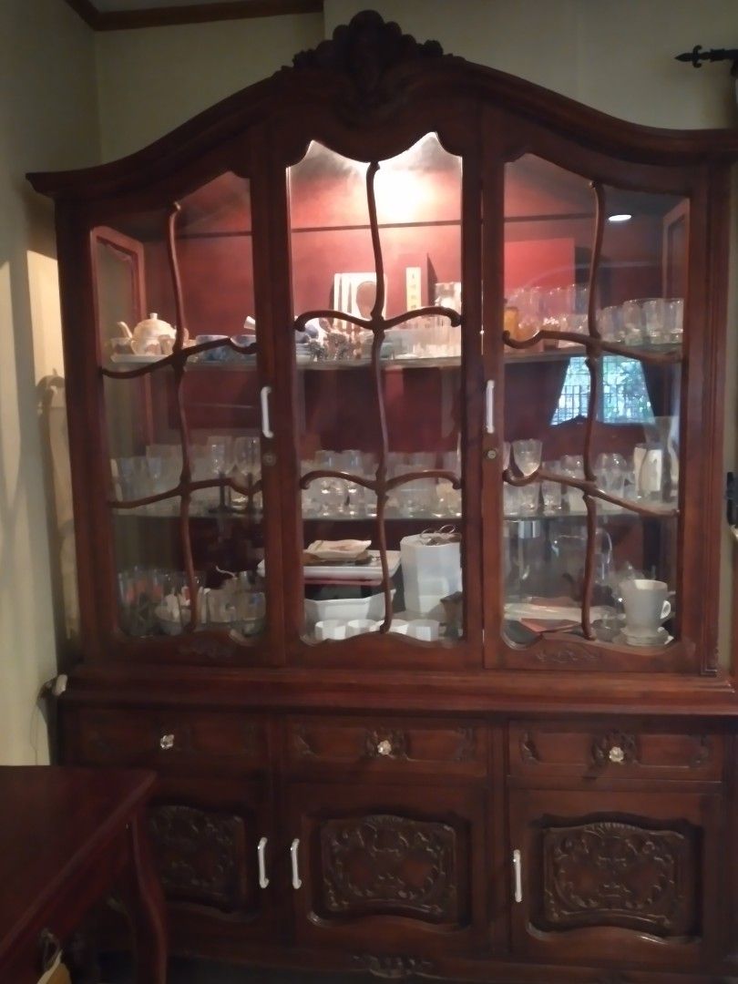 Antique Wooden Display Cabinet (Category: Shelves, Cabinets & Racks) located in Manila. Submitted by janetmelga46306 (Listing ID 1437213062, Image 1). Description: - Antique wooden display cabinet - Features glass panels and shelves - Dark wood finish - Intricate carvings on doors - Includes separate storage cabinet - Perfect for displaying collectibles - Adds vintage charm.