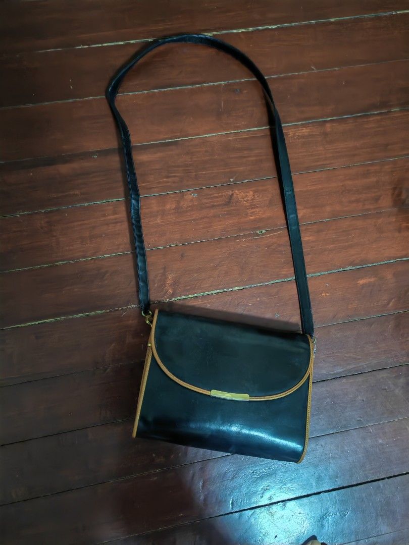 Bally Black Leather Shoulder Bag (Category: Luxury Bags & Wallets) located in Makati City. Submitted by brooklyn87370 (Listing ID 1437400175, Image 1). Description: - Bally shoulder bag - Black leather with tan trim - Gold-tone clasp and hardware - Long shoulder strap - Flap closure - Made in Italy.