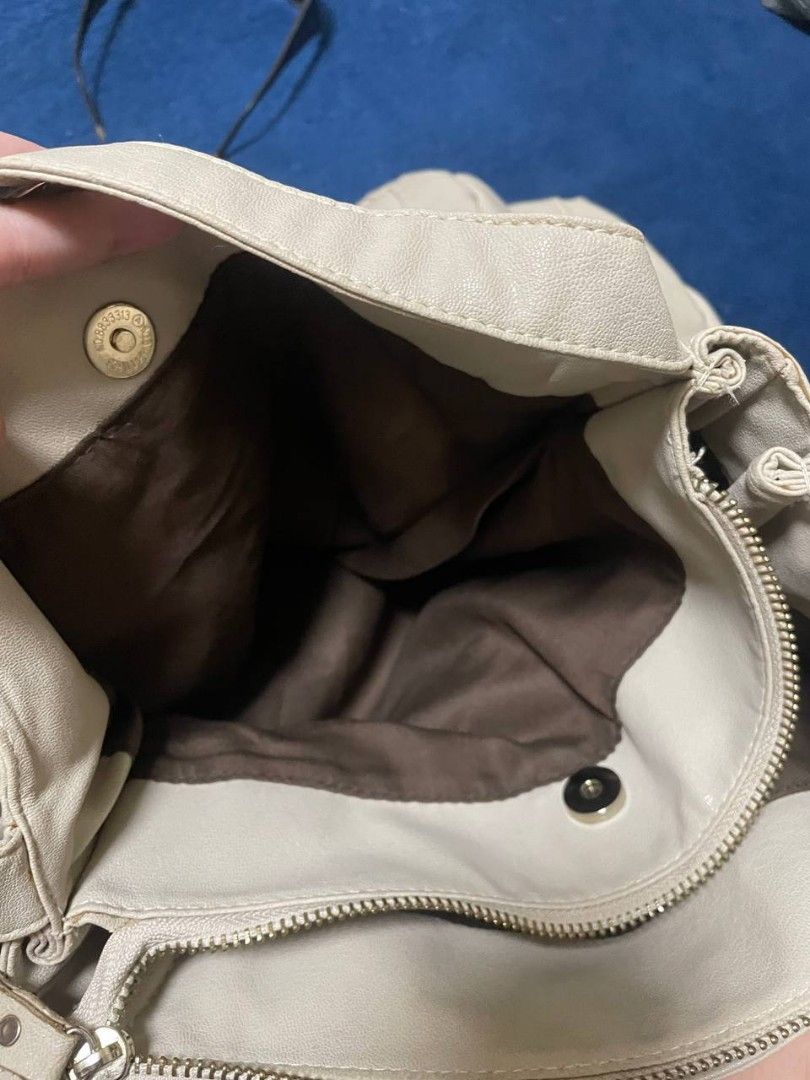 BA-YO Beige Shoulder Bag with Zipper Pockets (Category: Shoulder Bags) located in Makati City. Submitted by claire.1221 (Listing ID 1437244044, Image 3). Description: - Beige shoulder bag - Front zipper pocket - Main compartment with zipper closure.