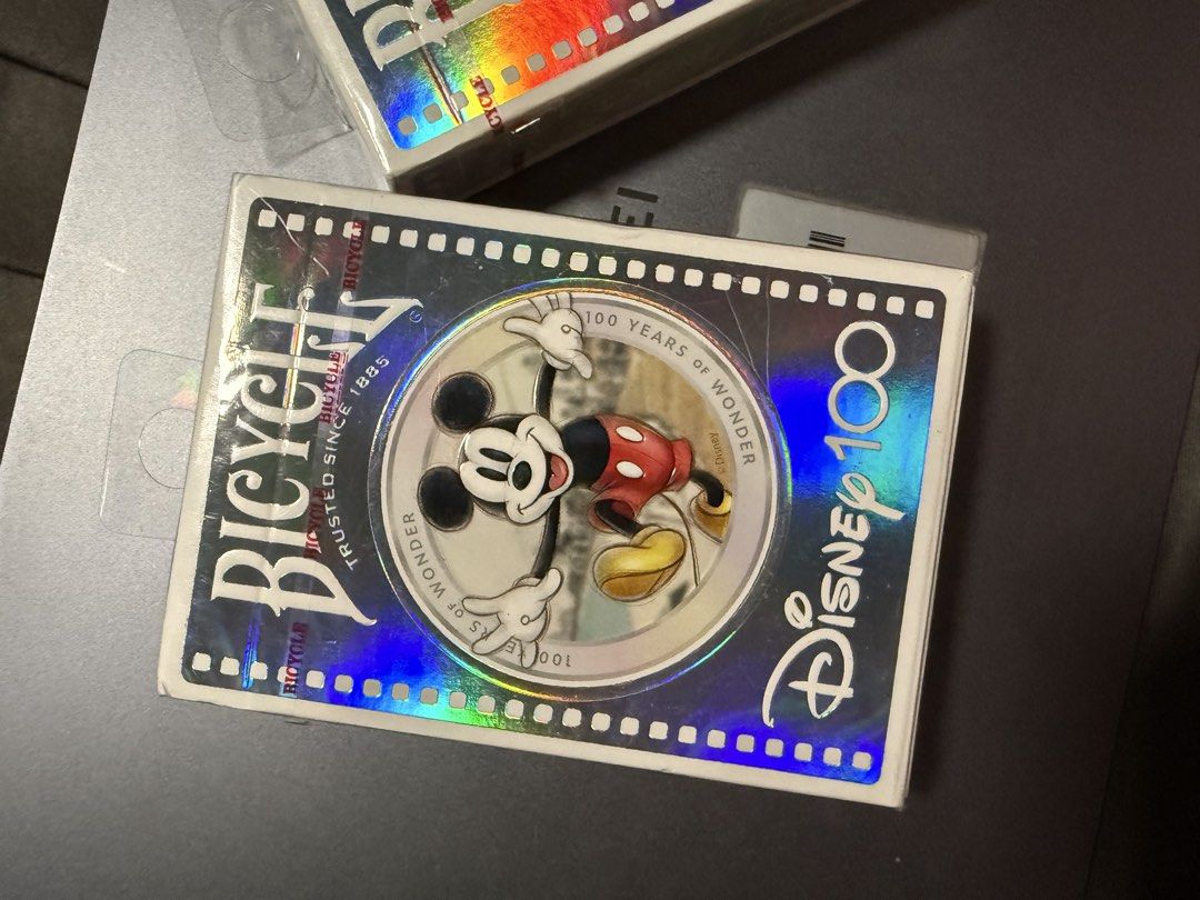 Bicycle Disney 100 Playing Cards (Category: Board Games & Puzzles) located in Taguig. Submitted by xandrascloset (Listing ID 1437297551, Image 1). Description: - Brand new, sealed deck of Bicycle playing cards. - Features a special Disney 100 design. - Holographic box design with Mickey Mouse. - Includes both the Bicycle logo and the Disney 100 logo. - Perfect for collectors or card game enthusiasts..