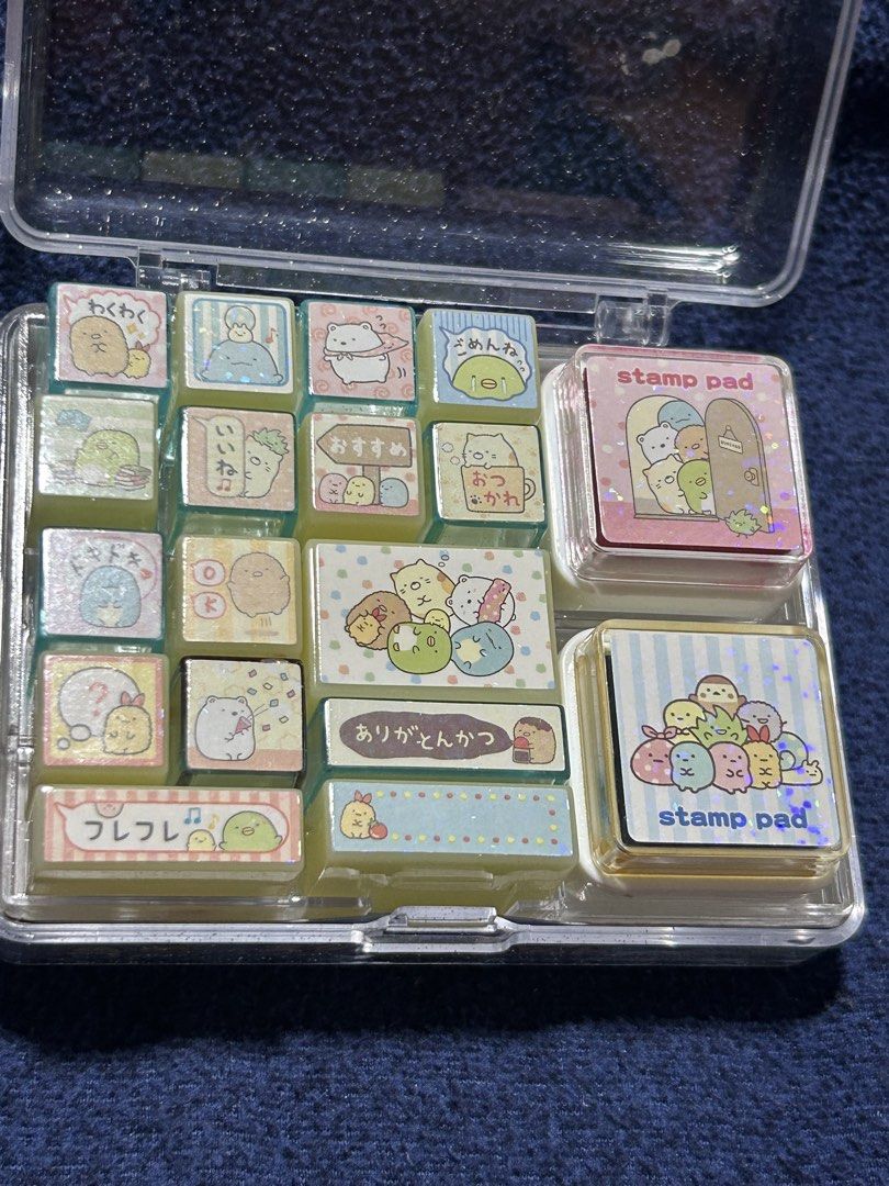 Bo33 Sumikko Gurashi Stamp Set (Category: Stationery & School Supplies) located in Angeles City. Submitted by zyeplustradings (Listing ID 1437212420, Image 3). Description: Set Contents: This collection typically includes 16 individual stamps of varying sizes, along with 2 stamp pads for ink.Characters: The stamps feature popular characters from the San-X Sumikko Gurashi universe, designed for messaging and decoration.Storage Case: The entire set