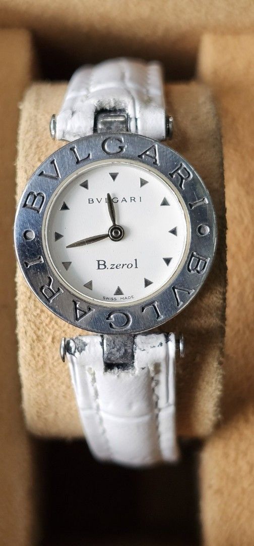 Bvlgari B.zero1 Watch (Category: Luxury Watches) located in Manila. Submitted by watchphil (Listing ID 1437266622, Image 3). Description: - Authentic Bvlgari B.zero1 watch - Features a pristine white dial - Elegant silver-tone hands and markers - Comfortable white leather strap - Includes original box and paperwork - Bvlgari logo engraved on the watch case - Model number and details on the watch back.