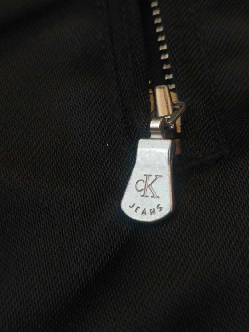 Calvin Klein Jeans Vintage (Category: Coats, Jackets and Outerwear) located in Quezon City. Submitted by emerson.lachica (Listing ID 1437316250, Image 3). Description: Calvin Klein Jeans Vintage -Size M -Dimes 20.5/28L -Excellent Condition -Multiple zipper -CKjeans Patch logo -Black Color -Made in Hong Kong - shell 100% Nylon - Lining 100% Acetate -(Care Over ).