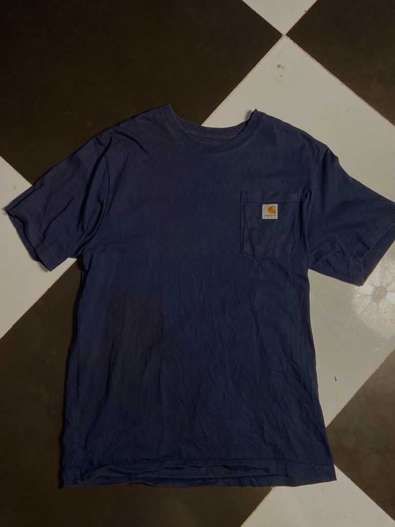 Carhartt Pocket Tee - Navy Blue (Category: Tshirts & Polo Shirts ) located in Manila. Submitted by playingros58430 (Listing ID 1437392180, Image 1). Description: - Carhartt pocket tee in navy blue - Classic crew neck design - Features chest pocket with Carhartt logo - Shows visible wear and tear - Durable and suitable for everyday wear.