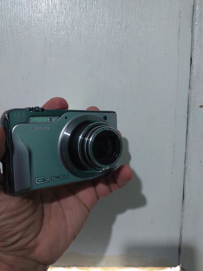 Casio Exilim Digital Camera (Category: Cameras) located in Quezon City. Submitted by jpnvintageonline (Listing ID 1437300556, Image 1). Description: - Casio Exilim Digital Camera - 10x Optical Zoom - 12.1 Megapixel Resolution - Built-in Flash - LCD Screen with issue dark sa side at parang may tumutunog - Includes Wrist Strap - Silver Color.